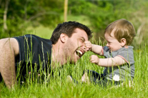 man_and_child_playing_grass